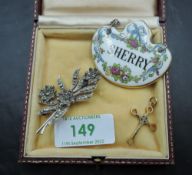 A 9ct gold cross pendant of decorative form, approx 1.7g with a ceramic sherry decanter label and