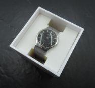 A Skagen wrist watch, no: 233LSSB having baton numeral dial to black face on woven strap