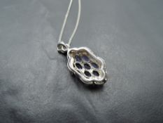 A silver pendant having tanzanite style stones in a decorative lozenge shaped mount, approx 18'