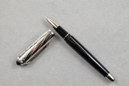A Cartier Rollerball having black barrel, Strobe light effect etched detail to silver cap and Blue