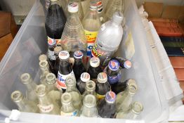A box of vintage and retro Pepsi bottles, some still having contents!