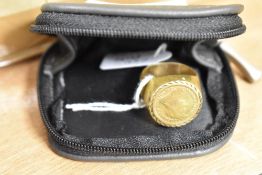 A gold plated ring with copy gold coin decoration
