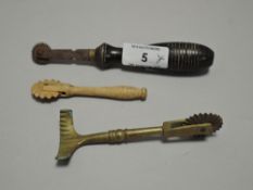 Two vintage pie or pasty crimping wheels, one brass and the other wood also included is a copy