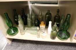 A selection of glass advertising and similar bottles including ceramic Westwell Blackpool and coffin