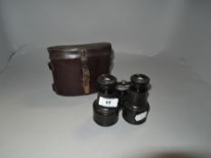 A pair of early 20th century binoculars with leather case