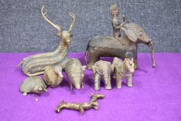 A selection of early 20th century Dhokra bronze figures including elephants, pig, turtle, deer and