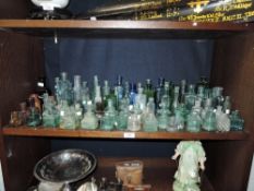 A large collection of early 20th century ink bottles and similar