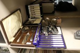 Four cased sets of cutlery with a selection of loose serving spoons