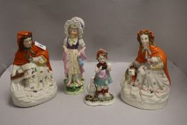 Three antique bisque figures including two Red Riding Hood, girl in bonnet and German figure with