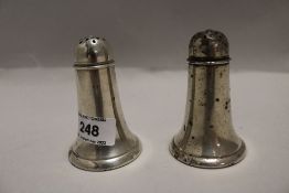 A pair of American Sterling pepperettes, with pierced domed covers of the tapering cylindrical