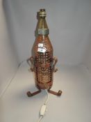 An Arts and Crafts styled lamp base hand worked copper body with copper tripod stand