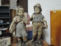 Two late Victorian terracotta figures of Dutch boy and girl fishing having had repairs 87cm tall