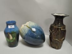 Two studio pottery vases, one teal blue with bird design,the other with embossed geometric pattern