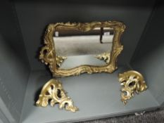 A modern gesso and gilt framed mirror with a pair of matching wall sconce
