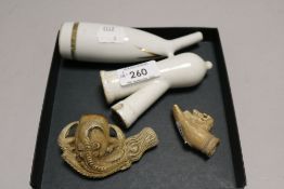 Two antique carved bone pipe bowls and a ceramic pipe with holder.