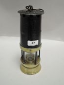 An antique coal or similar miners lamp having brass and iron case with no makers marks
