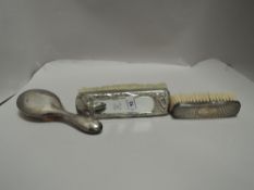 A white metal mounted Oriental design combination brush and mirror, of oblong form decorated with