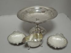A selection of 20th century silver plated table wares including shell design salts, gravy boat and