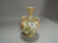 A Royal Worcester blush ivory twin handle vase with Greek style fluted neck and gilt borders with