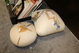 Two lace makers cushions with a set of turned and beaded lace making bobbins