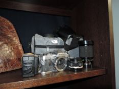 An Olympus om10 camera body with a Olympus 28mm lens and a Soligor zoom macro lens