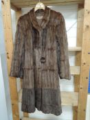 A Squirrel or similar fur coat,having Jean Dougal Macdonald,Sauchiehall St, Glasgow.
