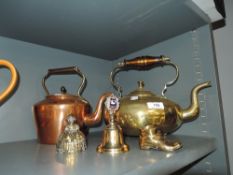 A late Victorian copper kettle with a similar footed brass kettle, bell ringer and ornaments