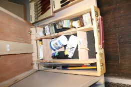 An artist portable easle container with paint supplies