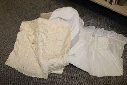 An early 20th centuy silk shawl having embroidery, sold with a child's dress and apron