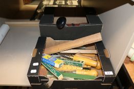 A selection of wood working tools including chisels, sharpening stones and measures