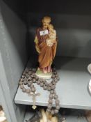 A plaster cast figure of Joseph and Jesus with a Catholic style Rosary bead set of carved wood