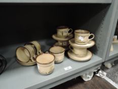 A selection of Denby Savoy tea cups and saucers with milk jug