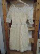 A late 1950s cream lace wedding dress having illusion strapless under dress with tulle lace