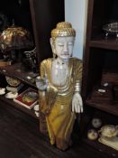An early 20th century wooden carved figure or statue of an Indian Buddha