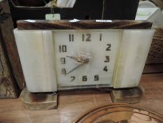 An Art Deco clock with stone cut body and classic design numerals