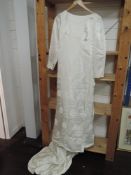 A 1960s wedding dress having long train and crotchet floral motif details throughout,bracelet length
