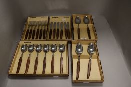 Five mid century cased Glosswood cutlery sets with teak handles