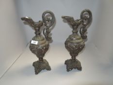 A pair of matching Victorian spelter Greek styled Ewers having a copper finish 33cm tall