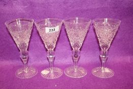 A set of four modern Cumbria Crystal wine glasses in a Grasmere style pattern