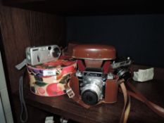 Three modern cameras including Yashica J, Exa Ihagee Dresden and a Sony Cyber shot