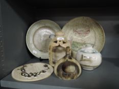 A selection of studio pottery including two decorated plates including mermaid design