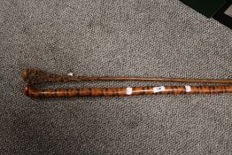 Two fine antique walking sticks or canes one from Petropolis having simulated tiger stripes and