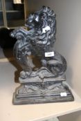 A mid Victorian cast iron door stop having rampant lion design approx 38cm tall