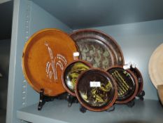 A selection of mid century studio pottery bowls and wall plaques including large decorated platter