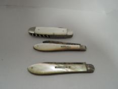 Three mother of pearl handled pocket or pen knives two having HM silver blades