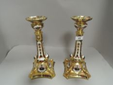 A pair of modern Royal Crown Derby Old Imari pattern candle sicks