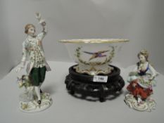 Two early 20th century classical figurines, one of lady, seated with rose in hand and hat perched on