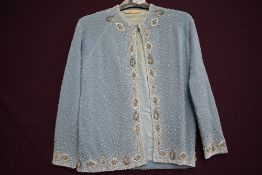 A 1950s powder blue heavily beaded cardigan.