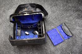 A wonderful early 20th century leather travel bag with fabric cover, monogrammed with A E to side,