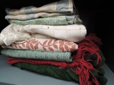 An assortment of vintage curtains, throws and fabrics, various eras and styles.